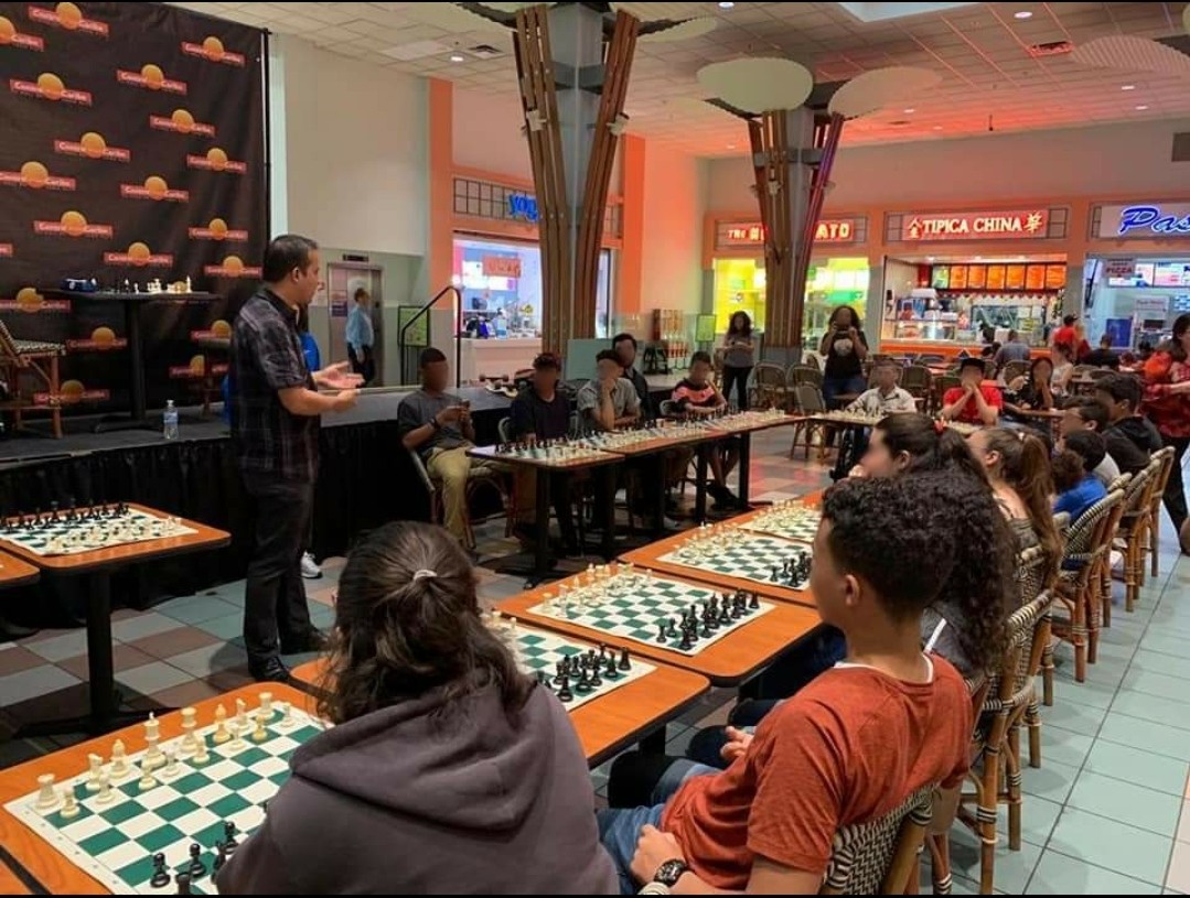 CBP's tweet photo. This week's #CBPeople: CBP Officer Francisco Cruz volunteers in his local chess club in Puerto Rico. Becoming a Chess Champion at 11 years old and inspired by his two children, Officer Cruz teaches chess, organizes tournaments, and impacts players of all ages. https://t.co/OUREs2TtPo