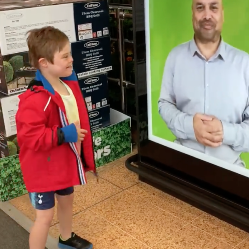asda's tweet photo. Ten-year-old Ernie was so happy when he saw a British Sign Language message welcoming him to his local Asda. Ernie, who has Down's Syndrome, uses sign language as one of his ways of communicating. Mum Helen: "It was really sweet, and Ernie loved it!" https://t.co/sFYc7qsfNS https://t.co/hAADe3nprL