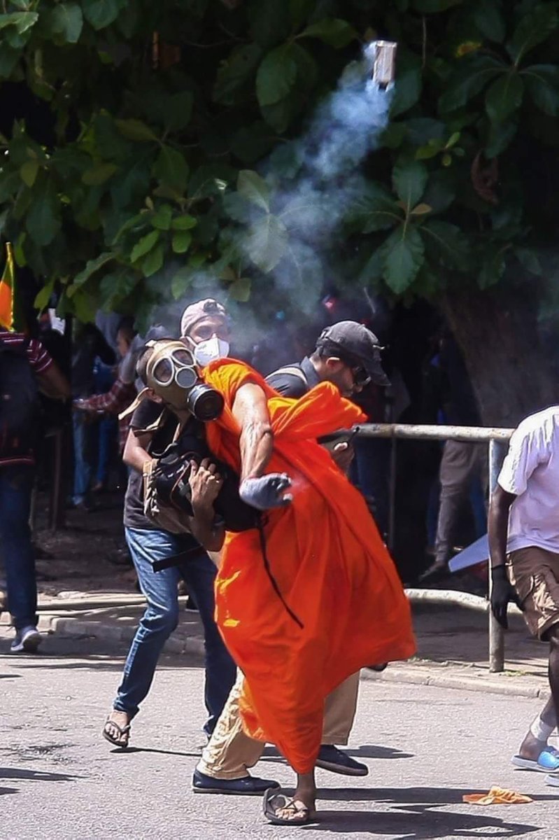 A Buddhist monk returns a teargas round to sender (the security forces) amidst the anti-government corruption uprising in #SriLanka.