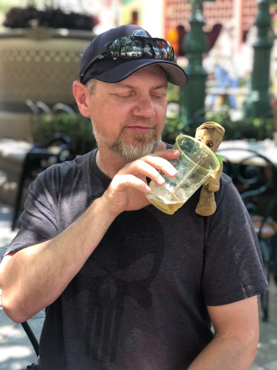 bobcam27's tweet photo. Hot day in Disney’s California Adventure. Gotta keep Baby Groot hydrated in a shady beer garden. https://t.co/qlDNoIRWLO