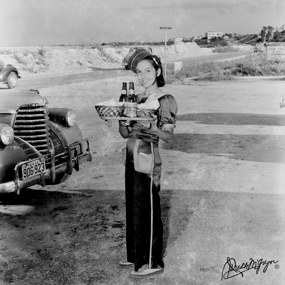 Happy #fbf! In 1940, Zackie’s Playhouse Drive-In was Corpus Christi’s leading sandwich dispensary, specializing in sandwiches &amp; fried chicken! Pictured is a Zackie’s curb waitress with a tray of fresh sandwiches and a couple of Lone Stars. Taken by Doc McGregor on 7/4/1940.🥤