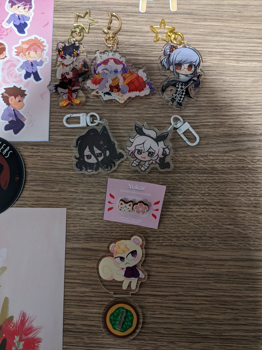 Second half! Howl/Sophie print, nyagreus/hypnyas charms and dapper lil animals from @swanprincex ! KH dice, stickers and dice tray from @LichtenStrange ! sdr2 charms from @cactuskhee ! Ouran stickers and Marshall amiibo standee from @sketcheveria ! 
(More credits below) 