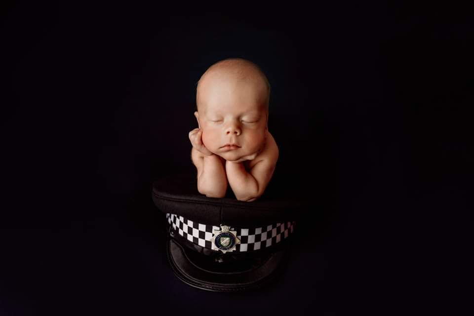 Hannah_2107's tweet photo. I have been silent on here for a few weeks, truth is this little boy decided to arrive into the world 8 weeks early! He is now 9 weeks old and thriving! One day, he may just wear one of these hats for himself, but for now he was trying Daddy's one on for size 👮‍♂️🚔
 #policefamily https://t.co/K0D0z8rirD