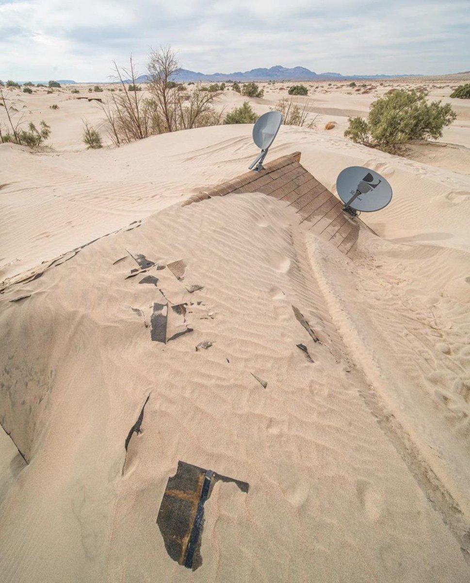 House abandoned and retaken by the desert in California.