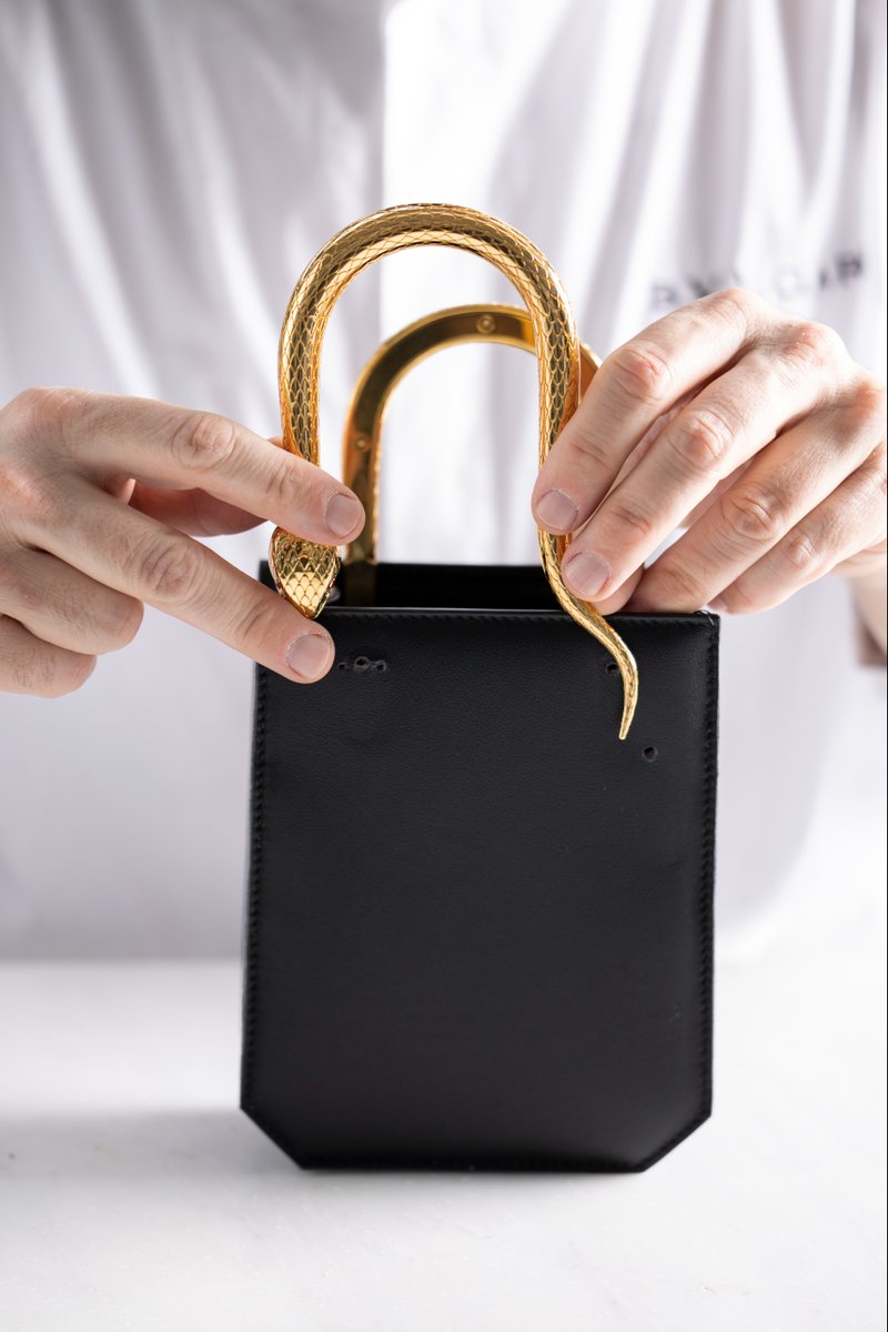 Bulgariofficial's tweet photo. #Bulgari presents its very own interpretation of the vertical tote trend. Attached to the Serpenti Vertical Tote bag’s body, the enticing moves of the #Serpenti handles are expertly molded. Shop at https://t.co/z4EDqQGw7B #BulgariAccessories #MadeInEden #FW22 https://t.co/bVgJd3Y11S