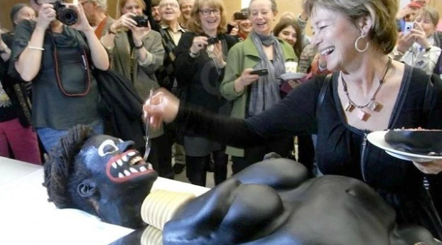 TrojanAid's tweet photo. WHAT ON EARTH is going on in the photo below?

The year was 2012, and that is Sweden's cultural minister with a "golliwog cake."

A short read about a brilliant stunt. Perhaps it will inspire other creative pranks about Europe's relationship with Africa.
https://t.co/vHoWRm6WtZ https://t.co/dcRrl8oIzL