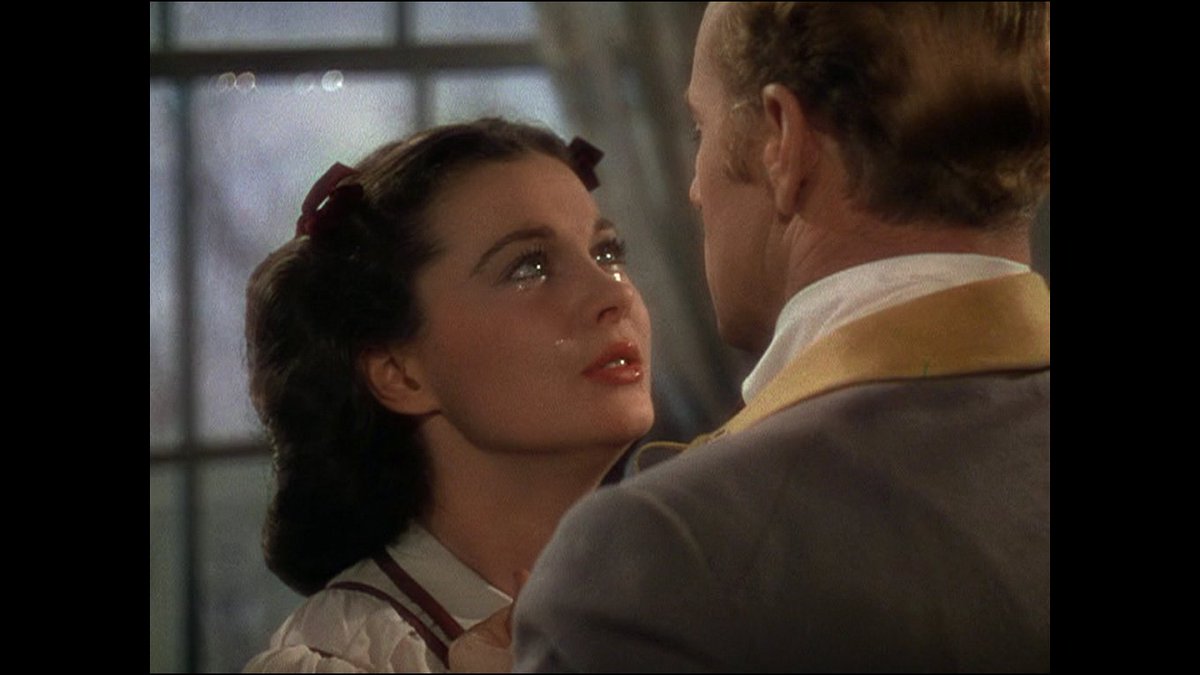 Vivien Leigh positively glistens as Scarlett O'Hara with Leslie Howard as Ashley Wilkes at Christmas in GWTW.  #ScarlettOHara #GoneWiththeWind  #classicmovie  #oldhollywood #GWTW #filmstars #oldmovies #classicbeauty #vivienleigh #glamour #LeslieHoward #AshleyWilkes #christmas