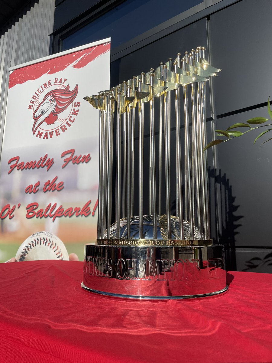 ScottRoblin's tweet photo. It’s here baseball fans! The Commissioner’s Trophy is on display at tonight’s @mhmavericks game. Good lineup pre-game of fans getting their photos. #WCBL #Mavericks https://t.co/CVw1rwhSdV