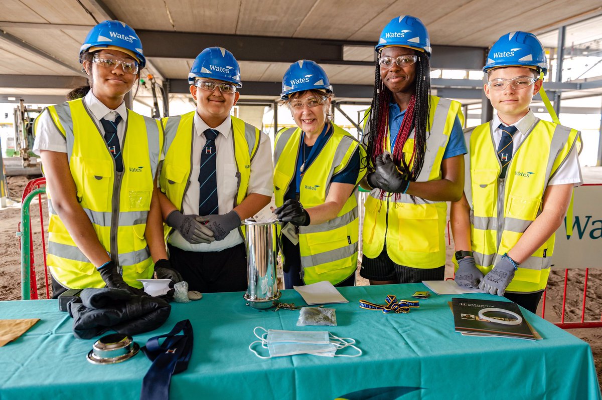 SallyKinchin's tweet photo. On the last day of term it was a double celebration at Harlington School.  Teachers and students buried a time capsule under the new library and Mrs Horrigan who has been Head Teacher for 17 years is retiring and was presented with an engraved spade.

@WatesGroup @Harlington_Sch https://t.co/V1XF6URkQ5