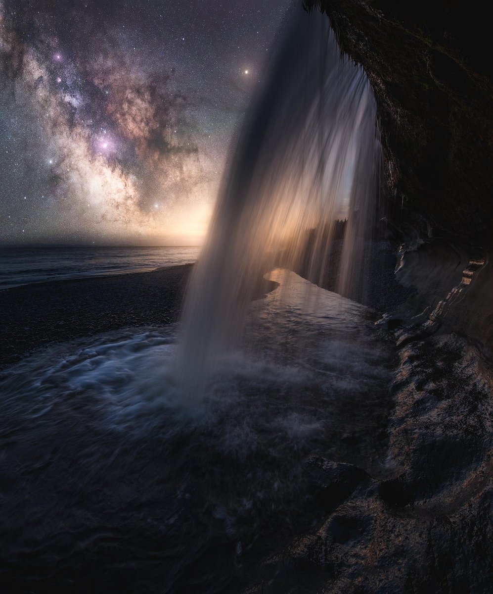 Greenwood shot this image at Vancouver Island, Canada. The image is a composite that he accomplished by photographing long exposures of the Milky Way and the waterfall separately. Later, he processed each of the images and stacked them to get this ethereal image.