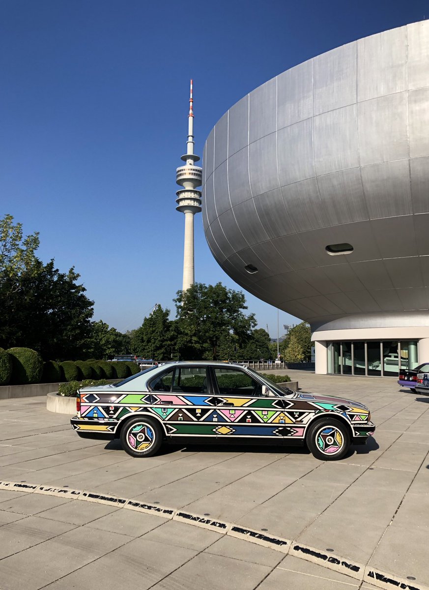 The iconic #BMW headquarters building turns 50yrs with an acrobatic abseiling display, and Mme Esther Mahlangu’s BMW 525i Art Car also getting an outing today.