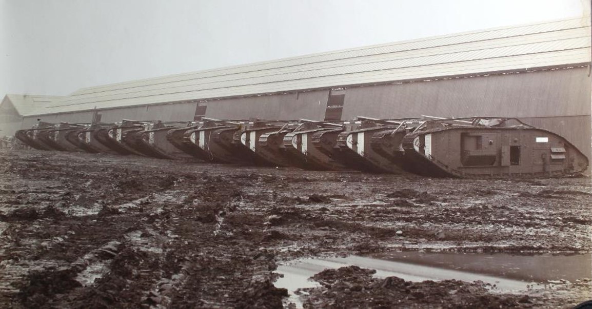 Almost-completed Mark V* tanks, outside the "Long Shop" of the Metropolitan Carriage Company's Old Park Works, Wednesbury, Staffordshire (now West Midlands).  They are waiting to be moved by rail from the works sidings to have their armaments fitted and be put into service.