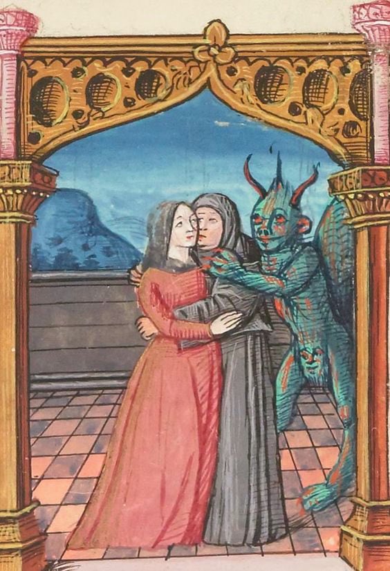 A medieval drawing of a teal humanoid demon with horns, wings, and a face on his crotch who has his arms around two embracing women whose faces are close together as if they are kissing