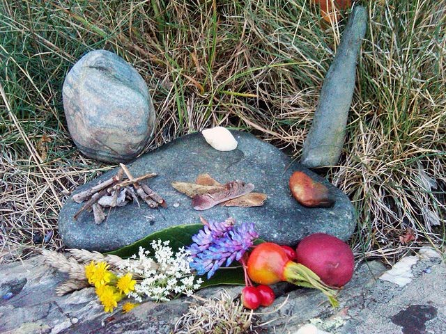She is looking at her altar and didn't see that the reader was looking at her behind a tree.

She was too concentrated and she closed her eyes.