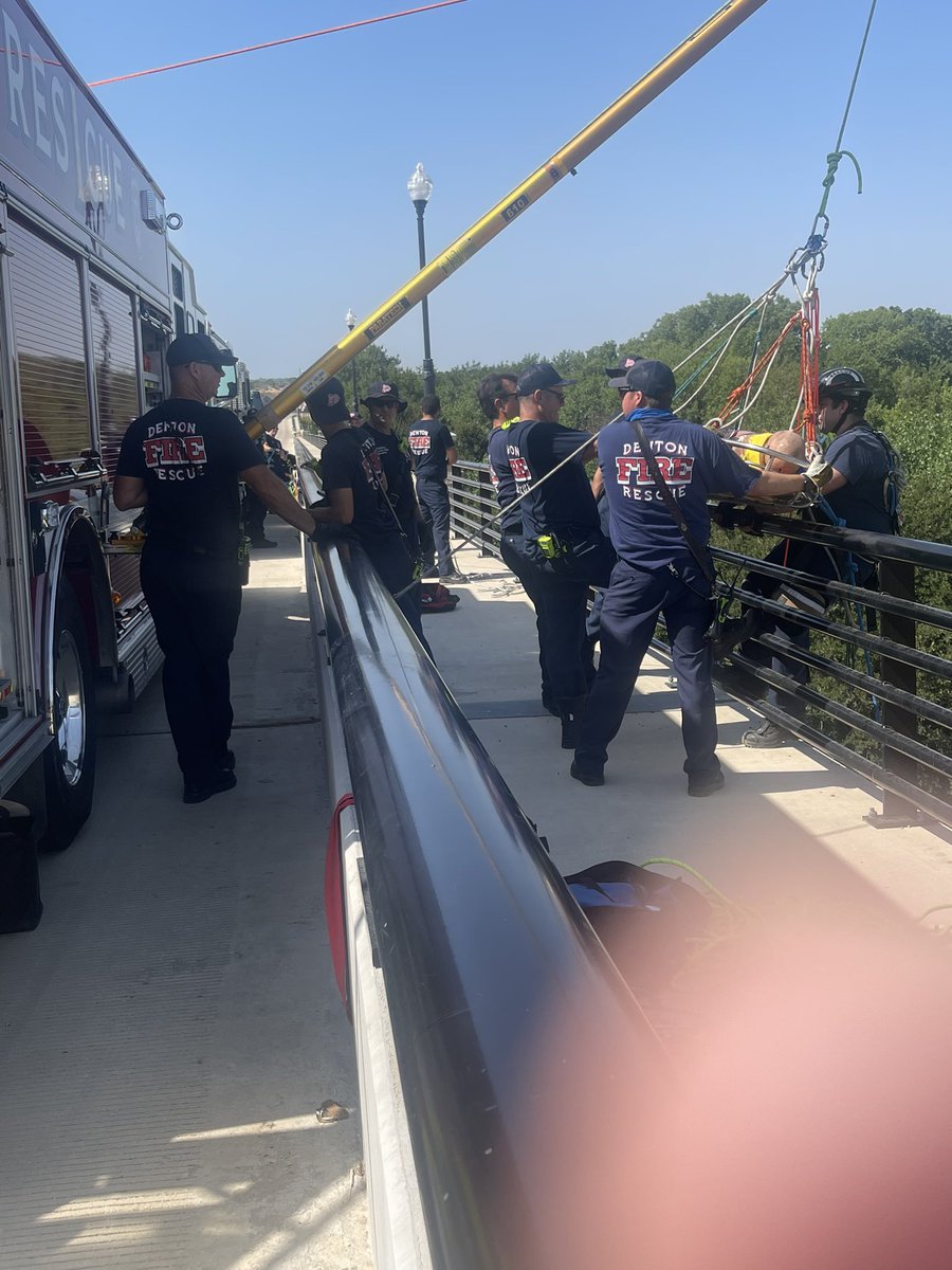 DentonFireDept's tweet photo. Crews getting in some high angle rescue training this morning on the south Bonnie Brae bridge. High risk, low frequency situations like this are not common for us but we’ll be prepared when it does! That is our specialty Rescue Truck based out of Central. @cityofdentontx https://t.co/mO20U11Q3Y