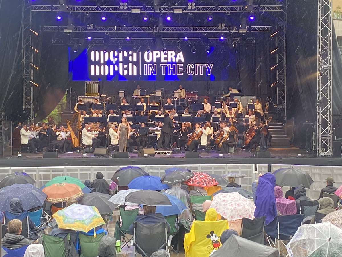 Philmb75's tweet photo. It wouldn’t be @Opera_North In The City @millsqleeds if it wasn’t raining!
We’re still here with @PritchardElin Inna Husieva &amp; David Junghoon Kim under the baton of Martin André and guiding us through @ForrestMark https://t.co/4h9HtSZNOj