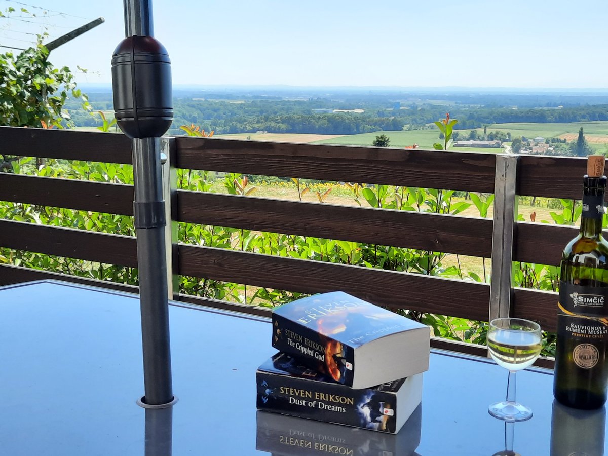 Meanwhile on a hilltop watching down on the vineyards and sunflowers in Slovenia... Book 9 finished, starting book 10: the finale of this epic series #MALAZAN      ...perfect holiday