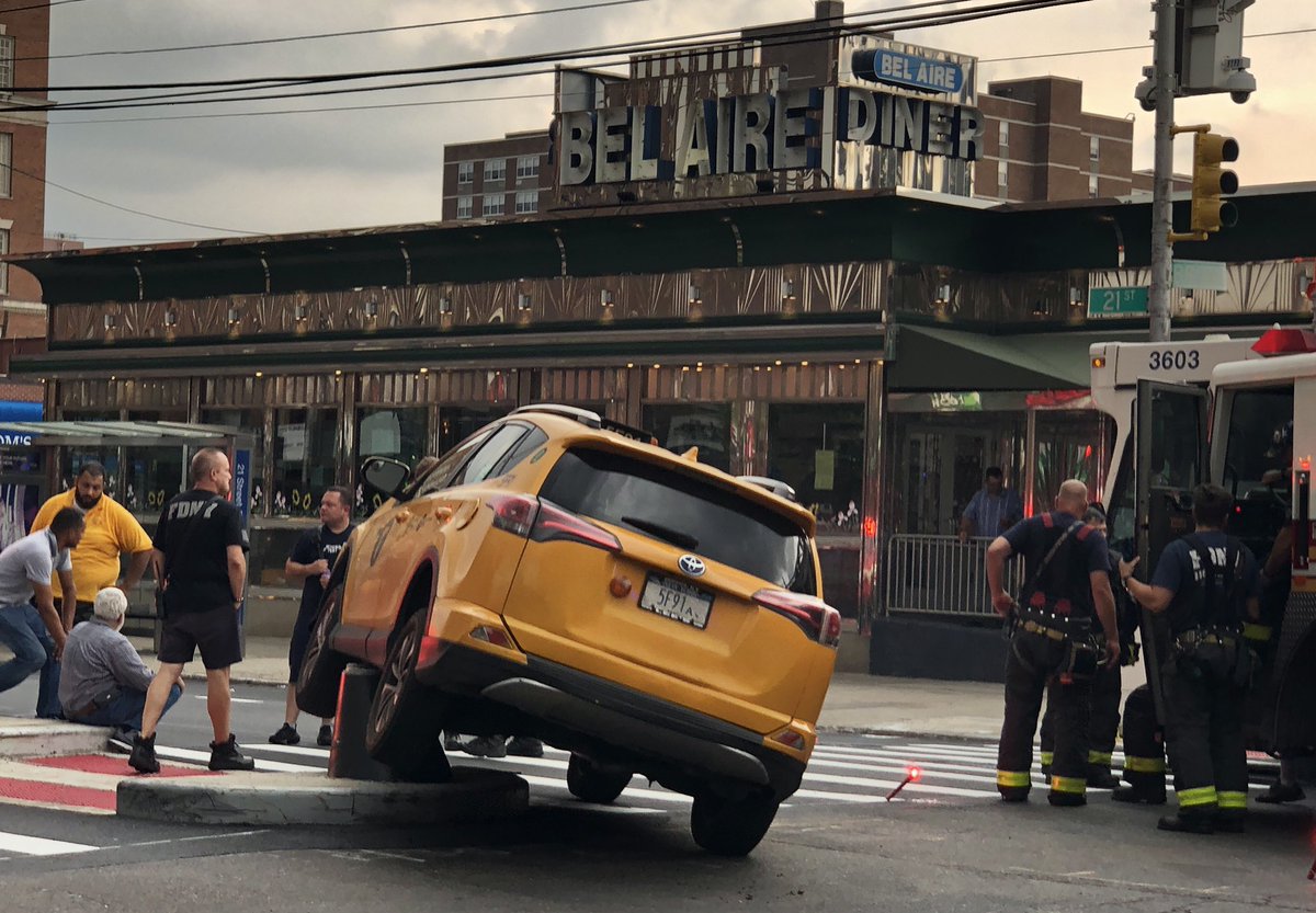 CSantucciPhoto's tweet image. A taxi got stuck atop one the new pedestrian safety fixtures along 21st Street and Broadway in #Astoria earlier today. Witnesses said that - very luckily - no one was seriously hurt. @NY1