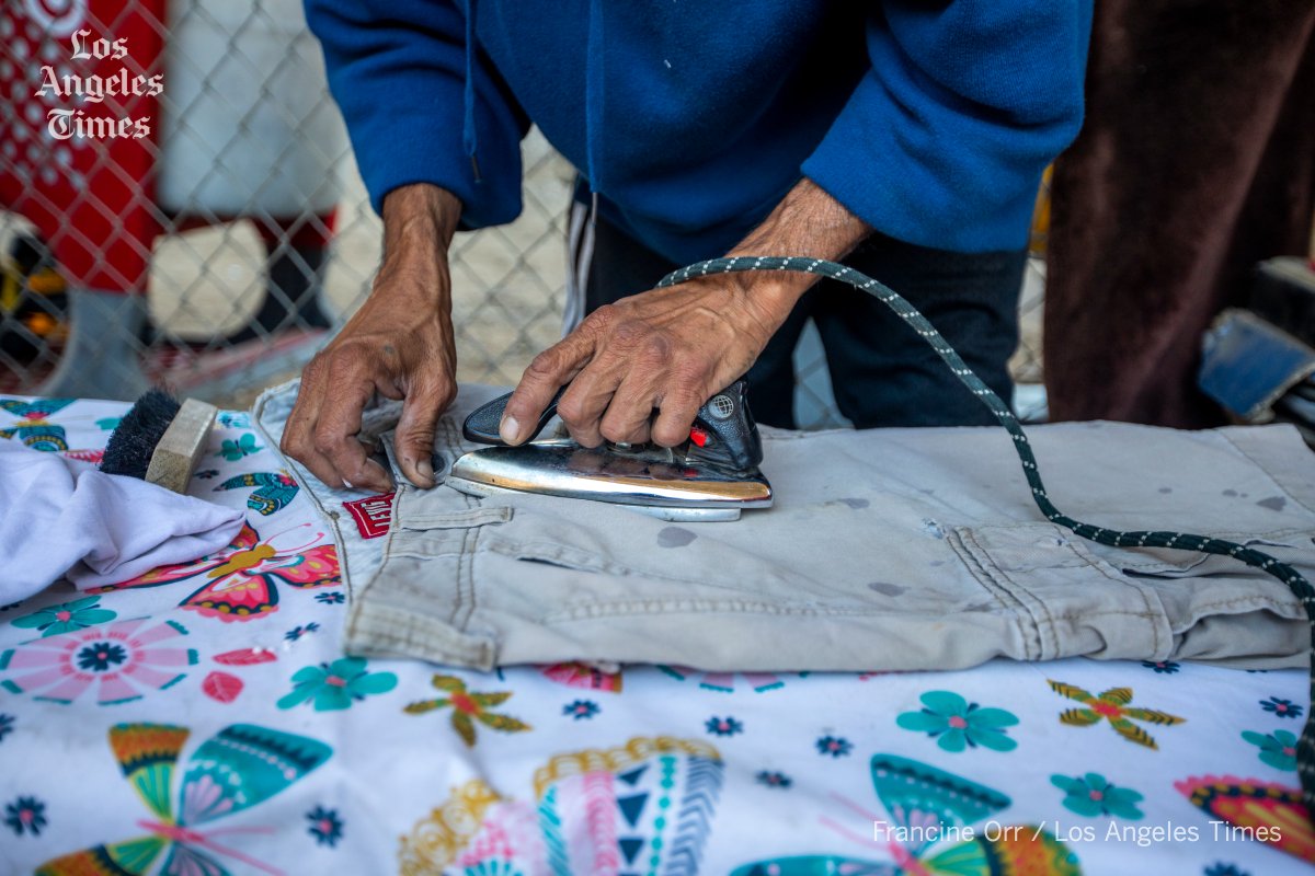 I look for things I haven't seen before on the streets. I have never seen a homeless person ironing clothes outside. Jose Luis Camargo said most of his belongings had been thrown out during sweeps. He saved an old little iron. @ConnorASheets @latimes latimes.com/california/sto…