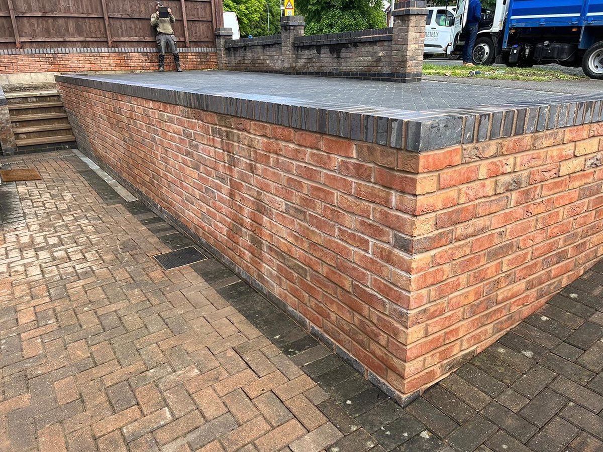 Charcoal driveway finished and a wall built