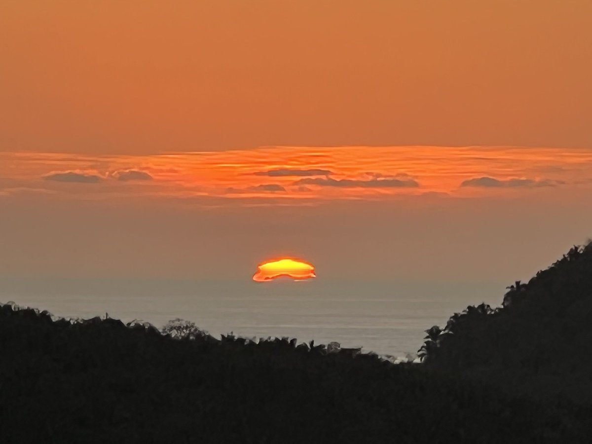 I took this photo off the coast of Mexico from Los Ayala, Mexico. The image on the horizon are the Islas Marieta Islands.  Flashing illumination above the sun was observed. It was sight to behold!