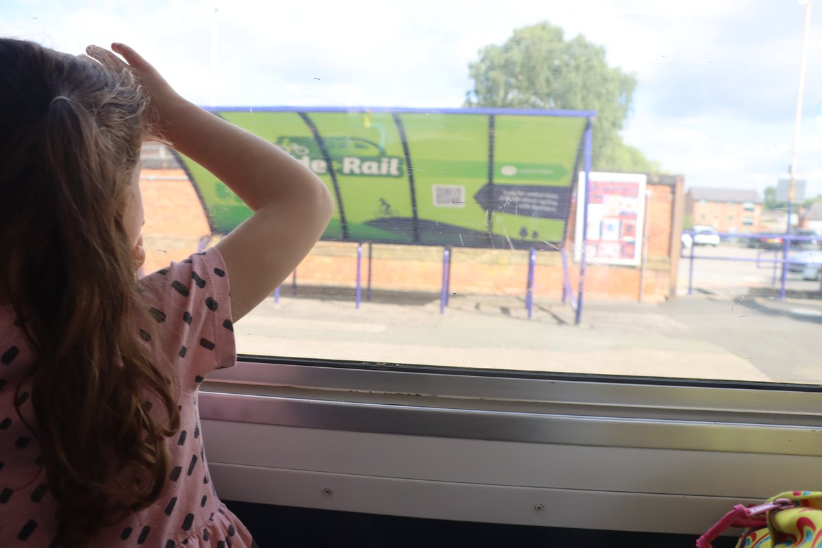 My granddaughter looking for her school's Jubilee poster on Altrincham Station. #throughthetrainwindow #midcheshirerailway