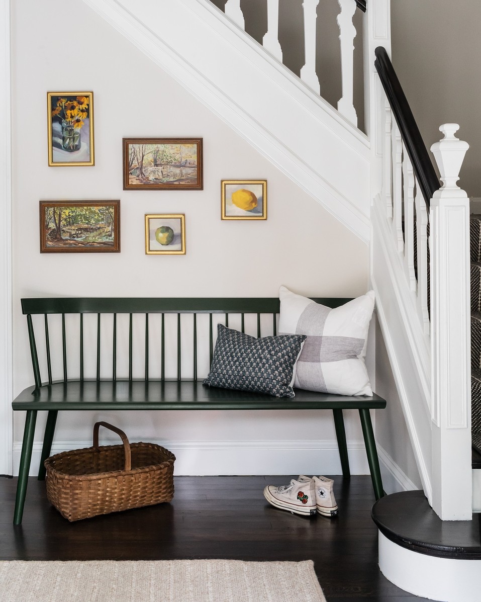 Adding a bench with comfy pillows is a stylish way to maximize the space under your stairs.

📸: @megmcsherryinteriors, <a href="/joyellewest/">Joyelle West</a>