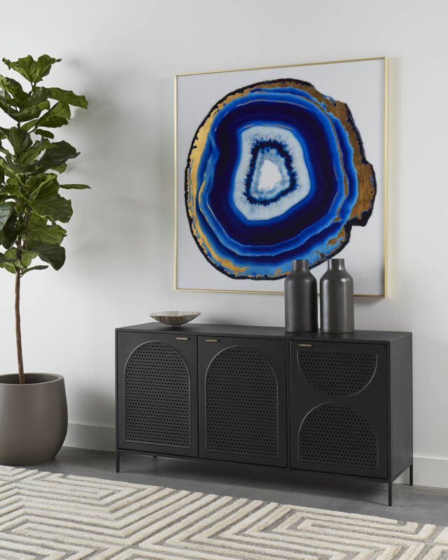 A timeless Aziza Sideboard by SUNPAN with a steamlined composition. Crafted with a black metal frame and completed with brass handles. Features open shelving and three cabinets with an arched perforated metal design.
-
Explore <a href="/SUNPANMODERN/">SUNPAN</a> on DesignerInc