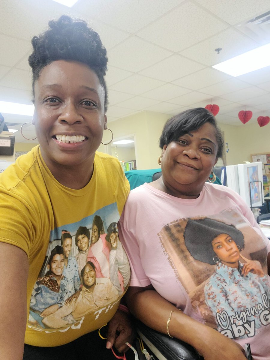 Bowman_ME's tweet photo. My coworker and I wore our Throwback Good Times T-Shirts today totally by coincidence. I think she was looking in my closet lol. Check out our photobomber in the 2nd one. 😂😂 #FunTimesAtWork https://t.co/VtTmIWYfko