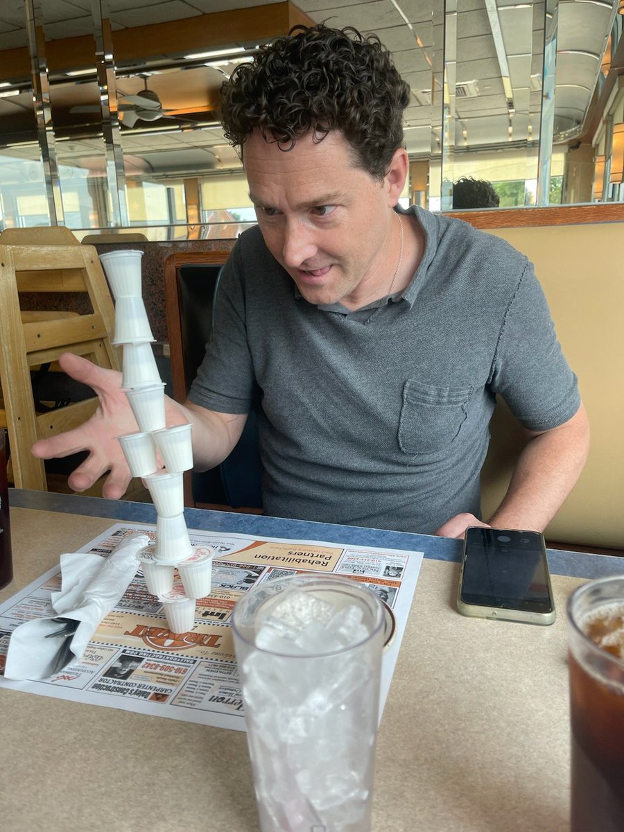 DanJKroll's tweet photo. Since there were no coloring books, I decided to entertain myself with an old friend: the leaning tower of creamers. I was summoning my inner 11 to keep the tower upright. #diningwithdan #StrangerThings https://t.co/0TCiYRWEnX