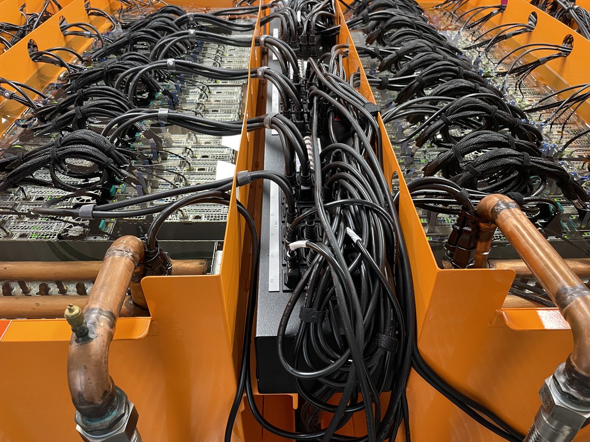 Today we toured the DUG super computer facilities in Perth. The computer processors are sunk into vats of what looked like water but which was actually … baby oil! We were able to dip our fingers into it, and see many cables and the banks and banks of processors under the liquid