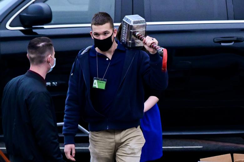 A person with the National Archives and Records Administration carries a large hammer engraved with the word Trump at the White House in Washington, January 15, 2021 REUTERS Erin Scott. 🔨