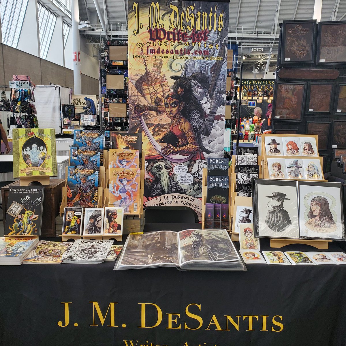jmdesantis's tweet photo. All set up in my favourite US city for @FANEXPOBoston! Table A911. I've got new fan art prints &amp; better highlighting my top titles!

#FanExpoBoston #comiccon #artist #writer #art #books #comics #Chadhiyana #RobertPhillips #RobertEHoward #LovecraftianHorror #MiddleEarth #DarkSouls https://t.co/fr434ejrd7