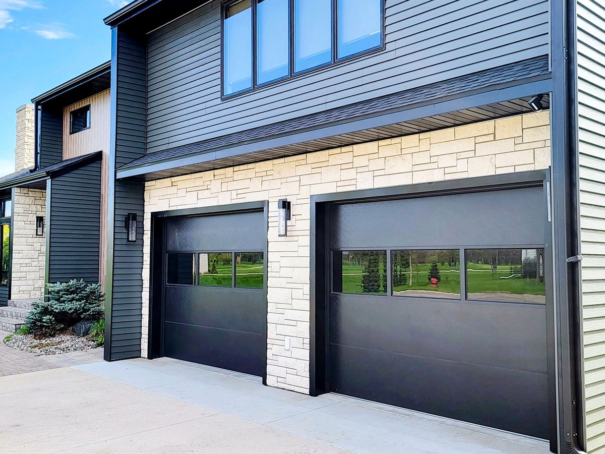 Don't be afraid to get creative and think outside the box when designing your #GarageDoors. Our Black Flush doors, combined with the sleek style of our FullView line, create the ultimate statement piece for any #ModernExterior!