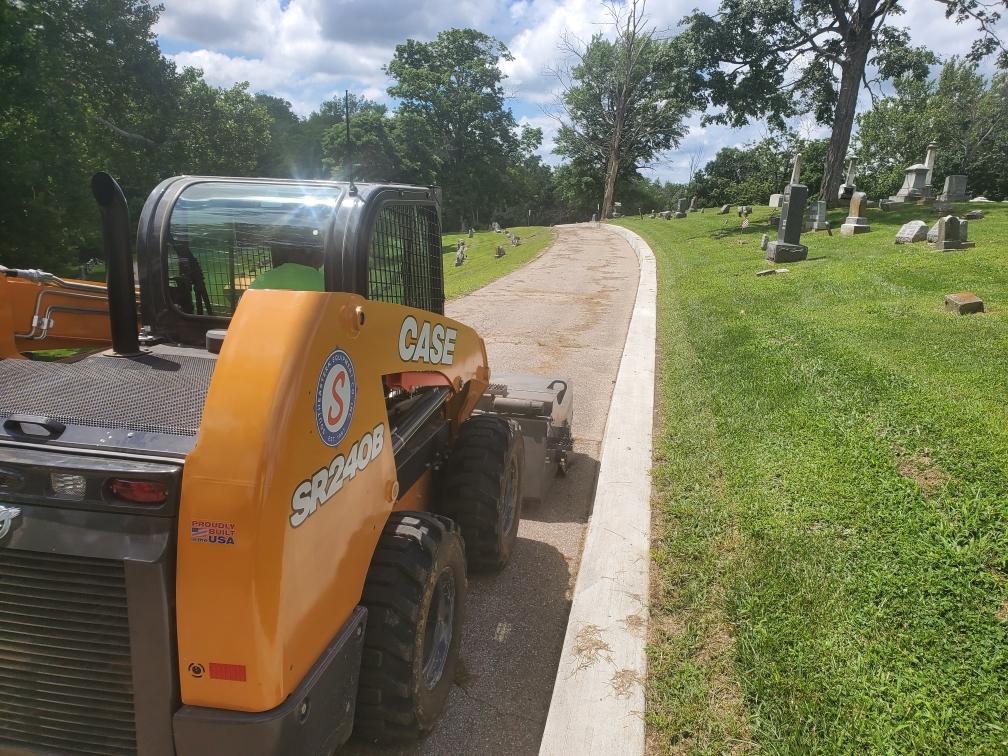 Woodhill Cemetery recently purchased a skid steerer with attachments using federal money. We're excited that this purchase will allow us to maneuver in smaller spaces, leave less damage to the grounds and gives us the ability to street sweep within the cemetery!