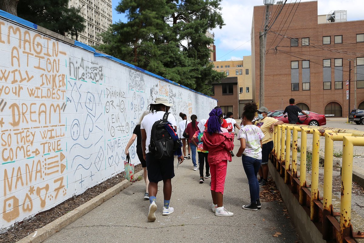 cadl's tweet photo. A mural project is underway at our Downtown Lansing branch, and we couldn't be more excited! This talented group of kids and educators, with @Muralmatics , have laid down a "Scribble Grid." The symbols serve to guide them when they begin adding the color and design. https://t.co/VNurvQ9tAI