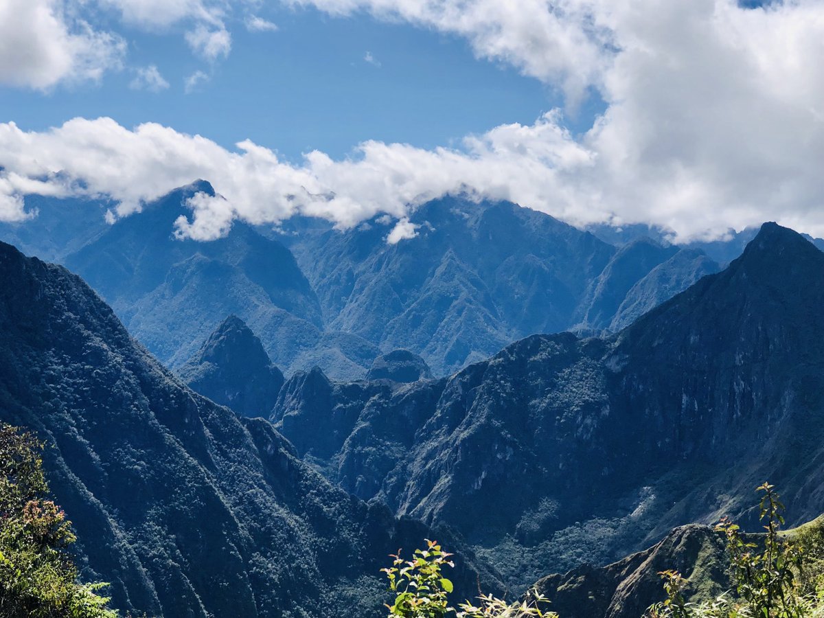 LuminoIQ's tweet photo. Trek day 8 we summit with a distant view of Machu Picchu & grateful that Inti has provided us with sun #PeruSummit #trekking #MachuPicchu Camino Inka visible cutting through the mountainside https://t.co/EkXnWRPeJd