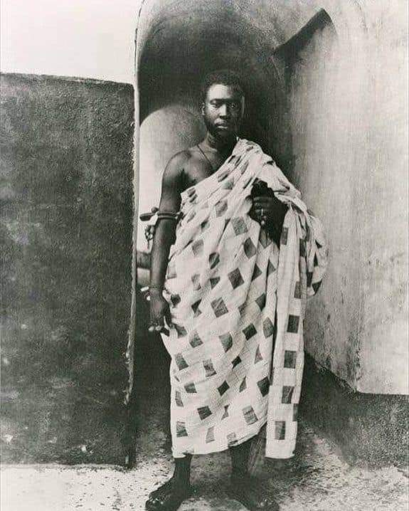 A photograph of Asantehene Prempeh I on his voyage to Seychelles. This photo was taken in the Elmina Castle, at the entrance to a suite of Apartments he was kept. The inscription "Prempeh Room" was written above the door he's standing at and is visible in some of the same photos.