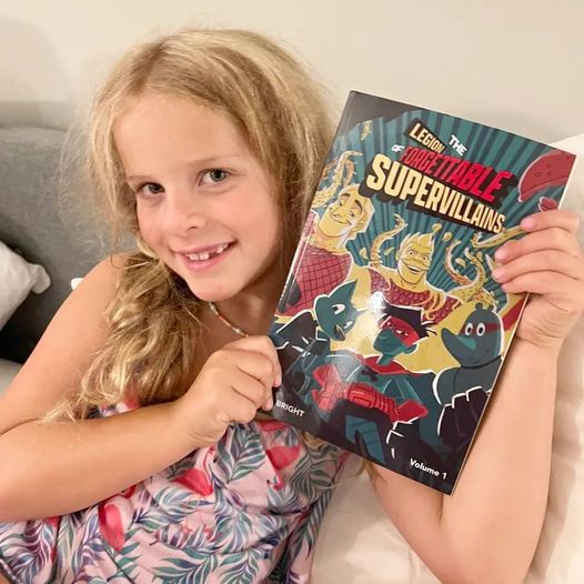 Remy got her paperback copy of my action-packed new graphic novel The Legion of Forgettable Supervillains from <a href="/DynamiteComics/">DynamiteComics</a> ! Now available everywhere and at jebright.com.