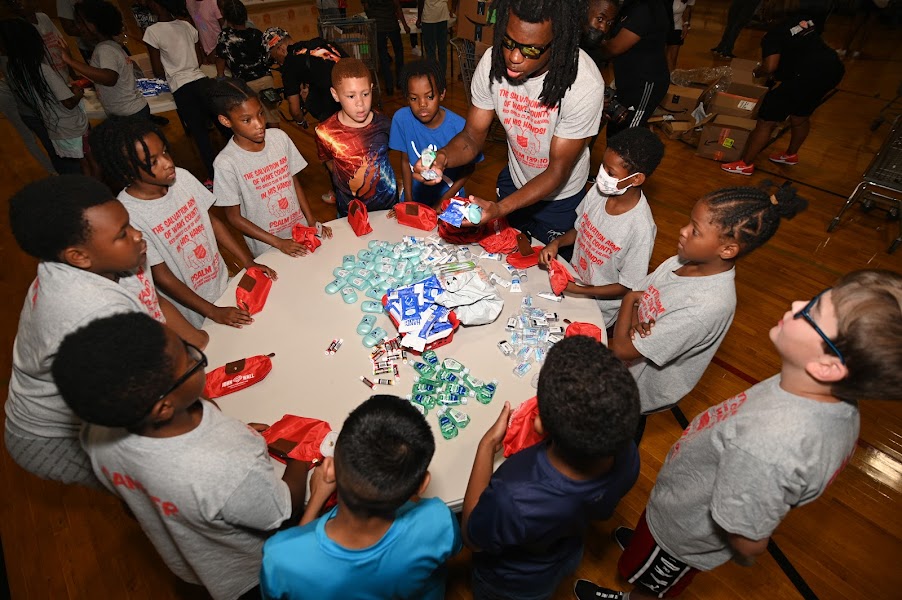 WakeCountyArmy's tweet photo. A great day today as #wakearmy Red Shield Club hosted @JohnWall and @JWFamFoundation There was a garden dedication to his mother, Ms. Frances Pulley. He also presented a check to TSA, and JWFF and our youth made hygiene kits for families in our shelter. Thank you John and JWFF! https://t.co/6tMwNoIGdW