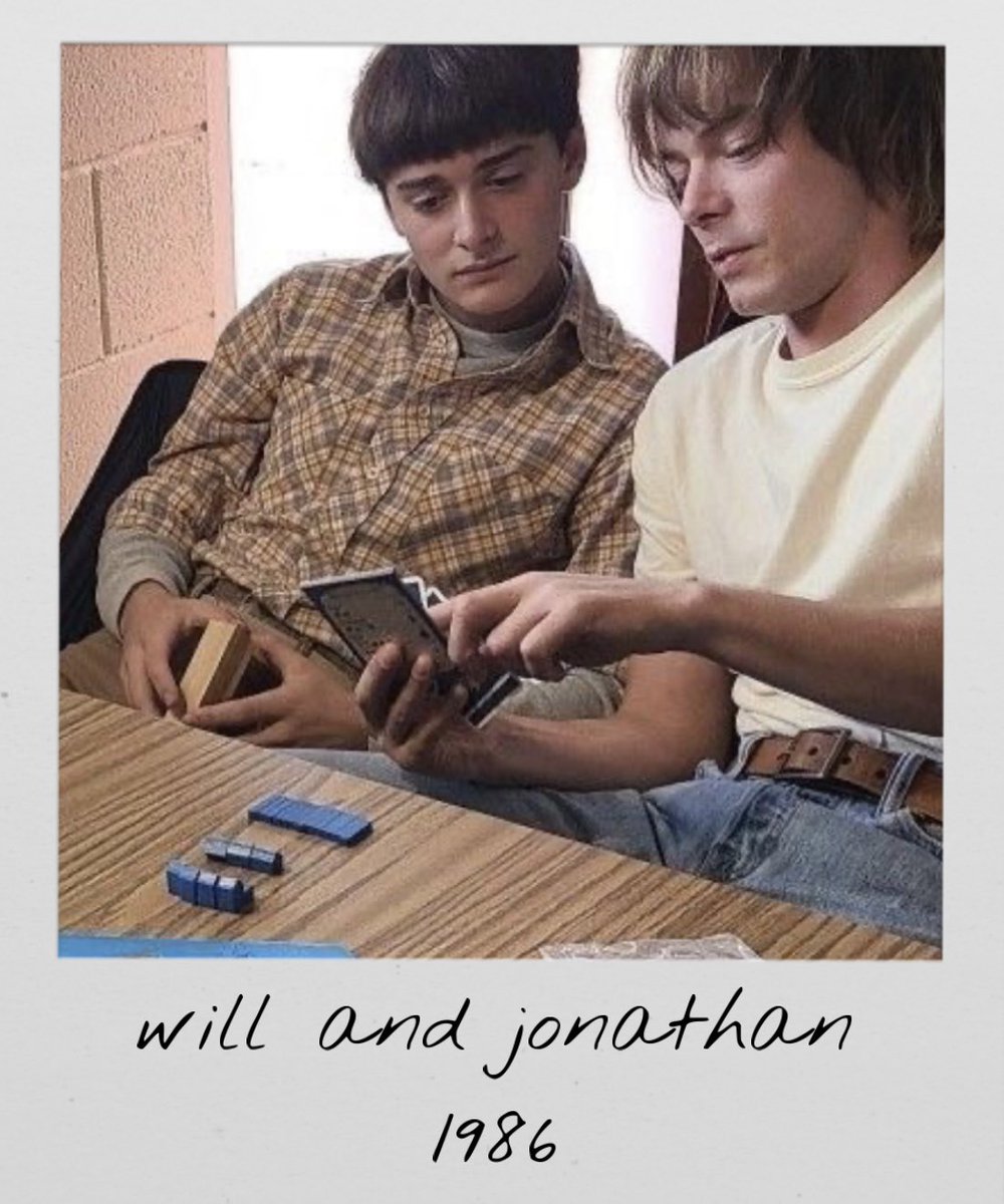 strngerpolaroid's tweet image. argyle takes a polaroid of will and jonathan playing a board game 
1986