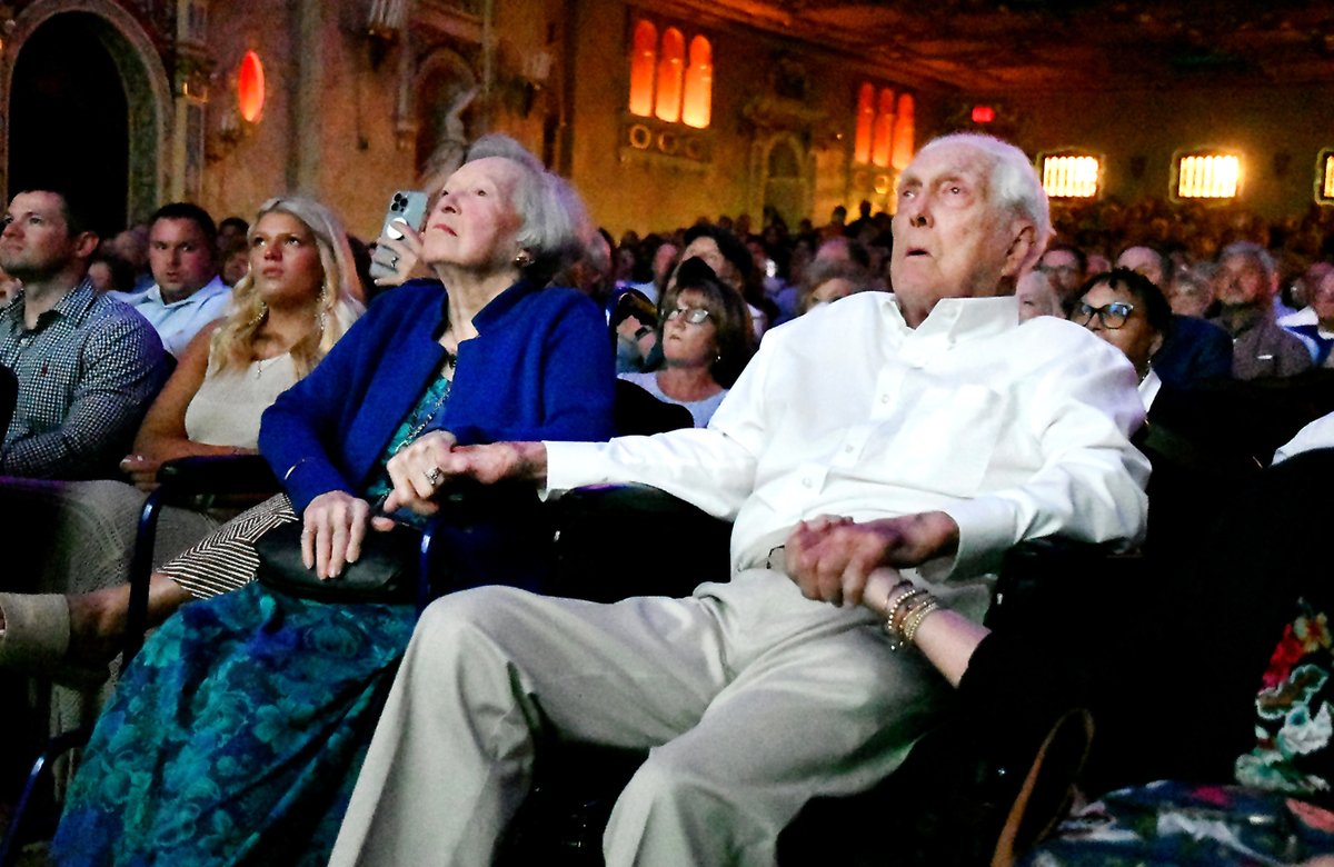 Betty and Carl Erskine hold hands as they sit in the front row of the Paramount Theatre watching the premiere of Ted Green's documentary "The Best We've Got: The Carl Erskine Story." For photos of the event go to: photos.heraldbulletin.com/Events/Premier…