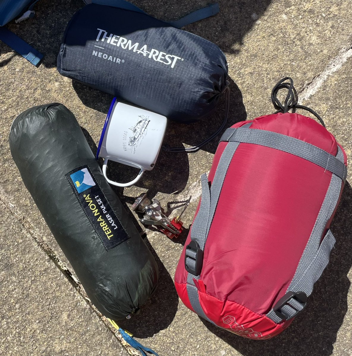 AnnDanielsGB's tweet photo. Tent, Thermarest, sleeping bag, cooker and a @SarahOuten happy socks mug. All weighing less than 2 kg, which is less than the weight of my rucksack and probably the amount of suncream weโll need. Off on an adventure with @pomoliver #swcoastalpath #happydays https://t.co/BXdD8vu1sL