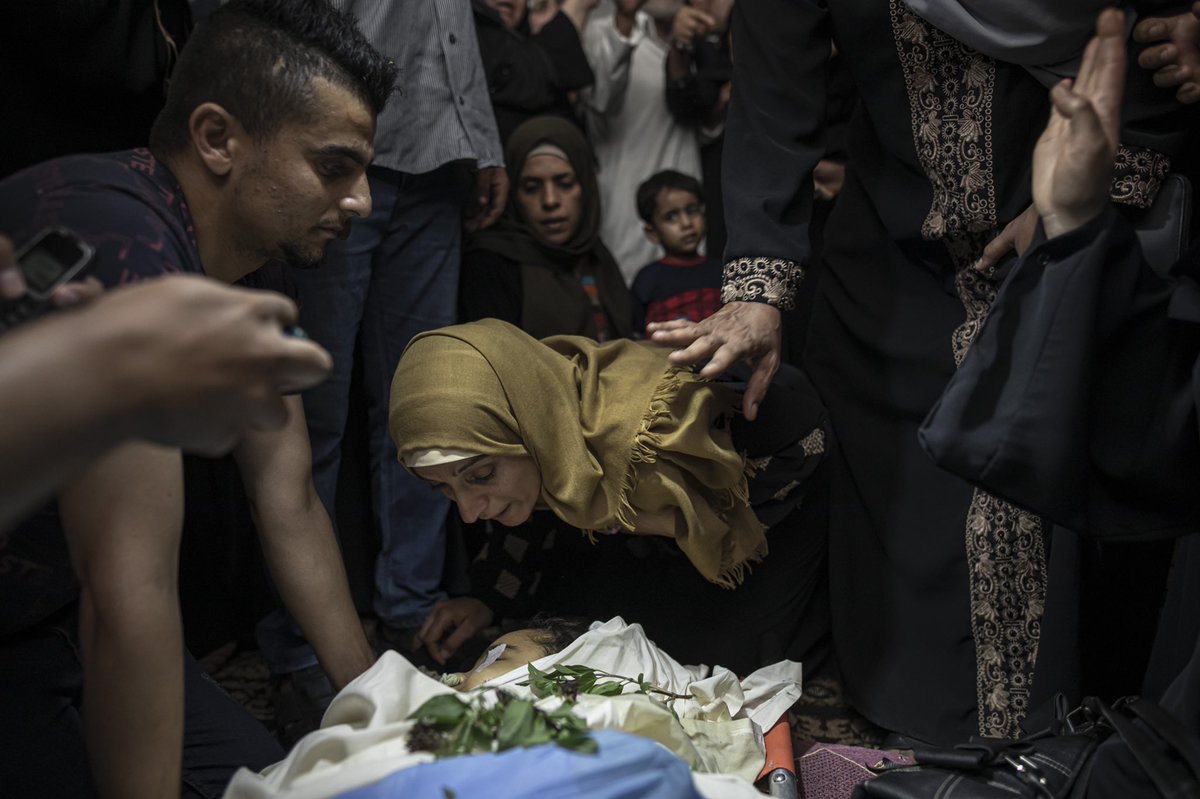 Mourners react during the funeral of 11-year-old Layan al-Shaer in Khan Younis, in the Gaza Strip, Thursday, Aug. 11, 2022. On Thursday, Layan died of her wounds after she was injured in last week's Israeli air strikes. (AP Photo/Fatima Shbair)