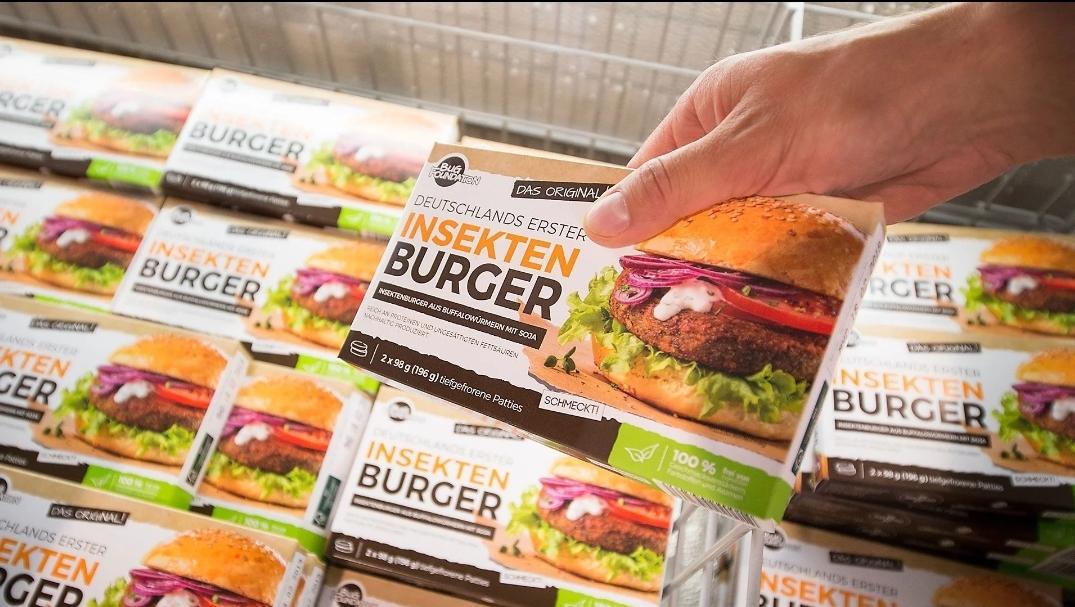 TheRealKeean's tweet photo. YUMMY: Bug burgers are hitting the shelves in Germany, featuring high protein and low saturated fat levels. Although they have slightly high sodium, they are the perfect food to fill your tummy during your next family cookout. They are not vegan, but they are tender and juicy! 🤮 https://t.co/EZb8xBSsuS