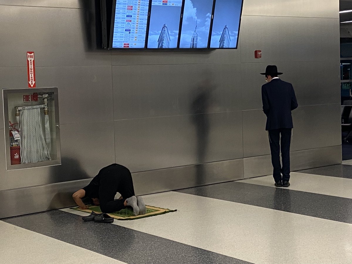 At JFK time for evening prayer for Muslims &amp; Jews. Both are facing East, one towards Mecca the other to Jerusalem. Sibling faiths can share a holy moment w/o compromising the other.  A simple truth to discover &amp; share. These 2 pray for Salaam/Shalom.  May their prayers be heard.