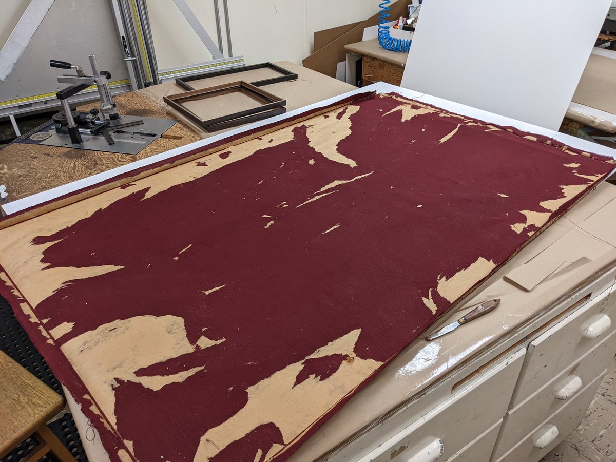 bad 70s framing. they used spray adhesive on both the flag, and the fabric underneath it. currently peeling cardboard off fabric. my boss doesn't pay for my obsessive qualities, she gets them for free