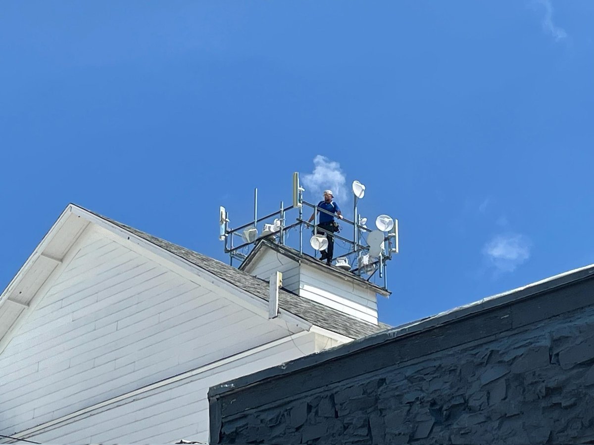 HighSpeedMT's tweet photo. This photo of Justin fixing a rooftop radio in 100+ degree weather is* featured next to the word "dedication" in the dictionary. Internet should be back to excellent shortly, neighbors!

*It isn't, but it should be. https://t.co/U6WoU2S8bB