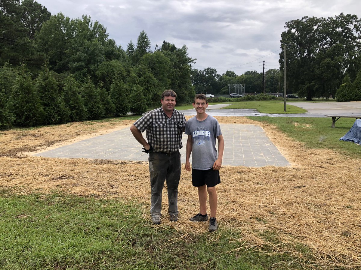 JoeAgan_EdS's tweet photo. Isaac spent the day in the rain today wrapping up his project with the help of his amazing mentor, Trip Booker.  This included cleaning up the site so he didn’t leave a mess. The patio is finished but he still has 8 benches to restore. Plan is to knock these out at home. https://t.co/PaJ2hDSRrC