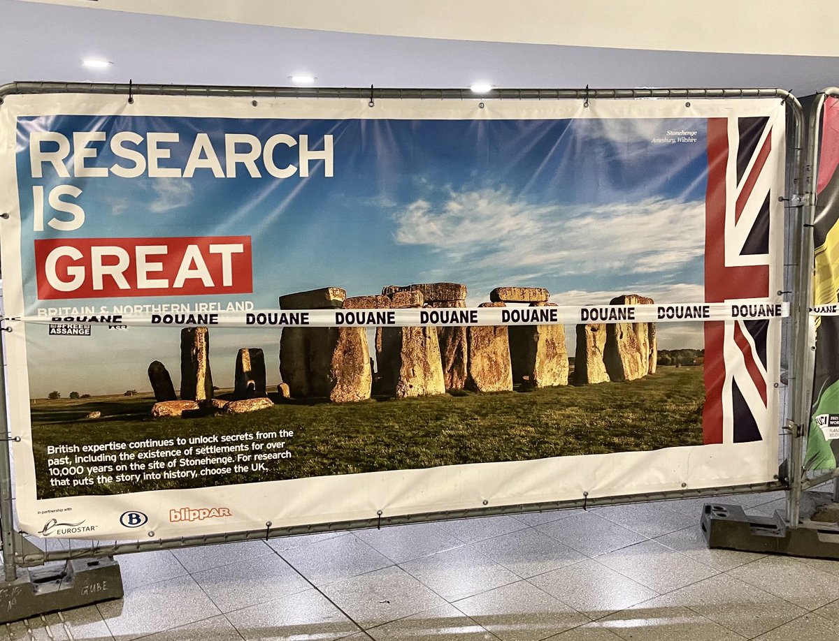 LeoCendro's tweet image. Poster at Brussels Midi Station extolling Britain’s research potential is now wrapped in a ribbon with ‘customs’ on it. Only way for this to be more on the nose would be if the tape was red